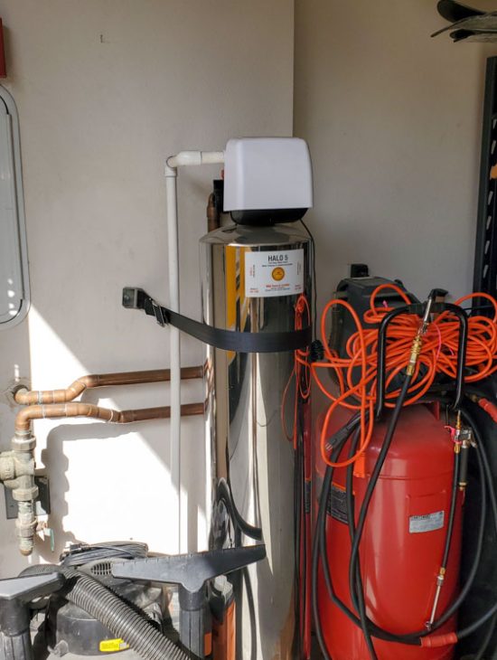 Water Filtration System Setup Water filtration system and storage equipment in a utility area, illustrating a clean and organized installation.